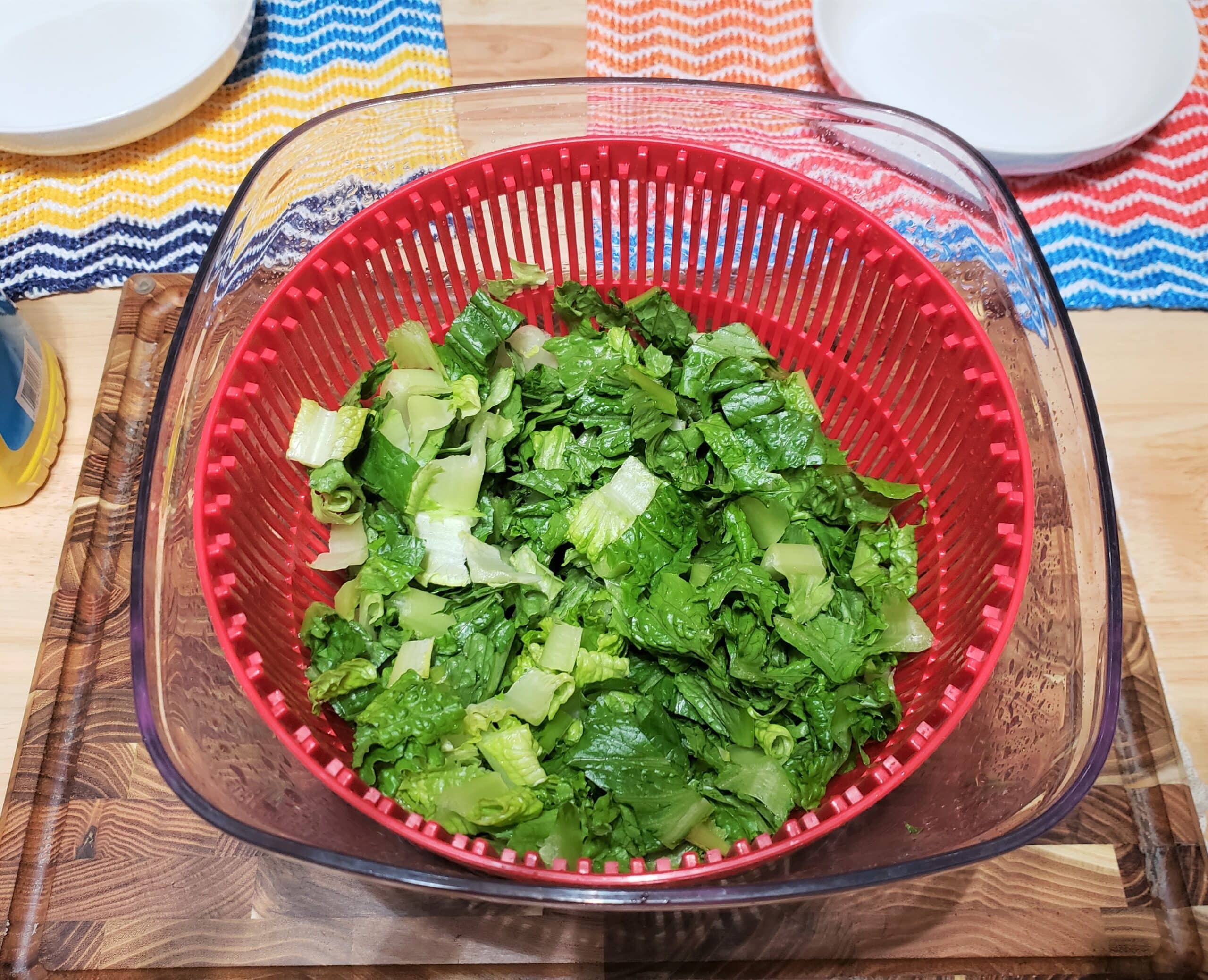 Chopped lettuce in red salad spinner